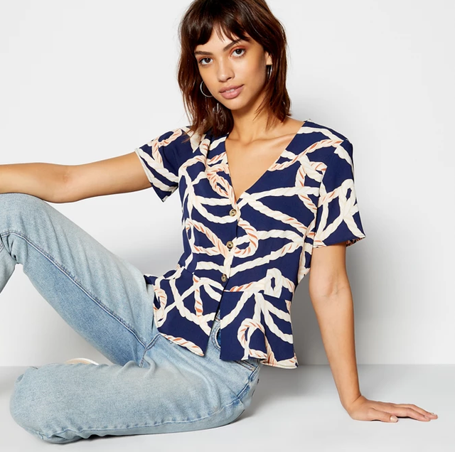 Clothing, White, Blue, Shoulder, Fashion model, Sleeve, Neck, Photo shoot, Sitting, T-shirt, 