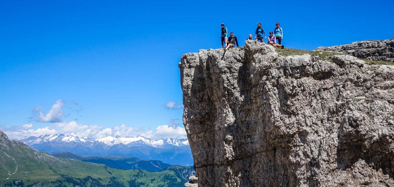 Runners on top of a mountain vista in the Italian Dolimites.