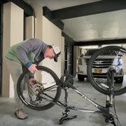 Stephen Colbert fixes a flat bike tire