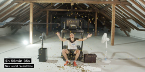 Matthias Kyburz celebrates breaking the 50K treadmill record with champagne and confetti.