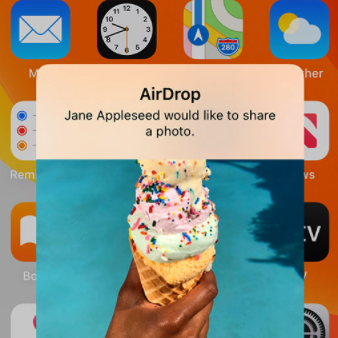 an iphone showing a pop up with an airdrop request to share an image