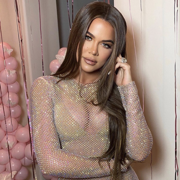 khloe kardashian with long brown hair and in a mesh sparkling bodycon dress pink streamers and balloons fill the background