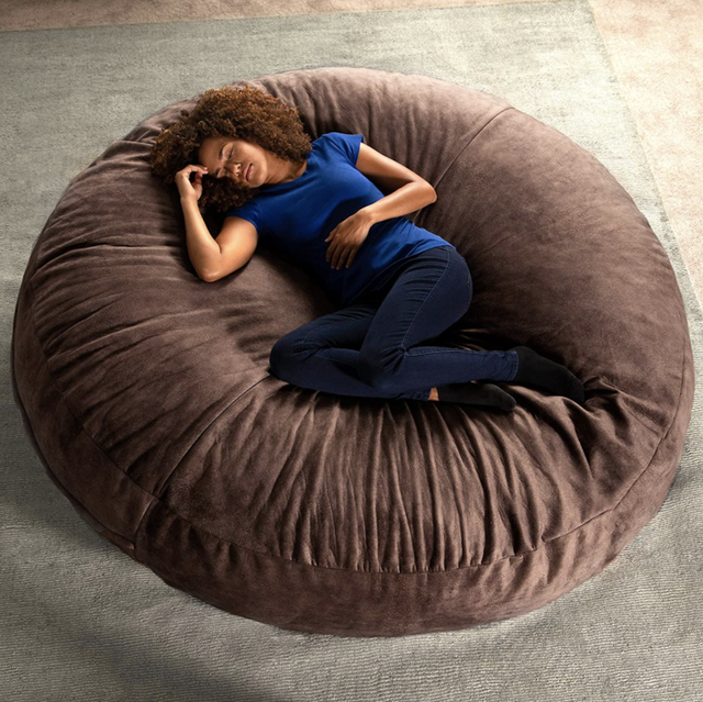 big brown bean bag chair with person laying on it