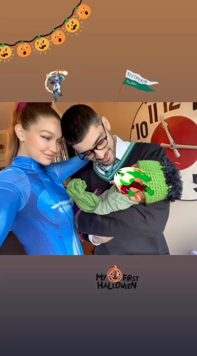 gigi hadid in a blue bodysuit, zayn malik in a harry potter costume, and their newborn baby girl in a hulk costume