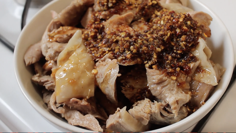 a plate of 口水雞 kǒu shuǐ jī, translated as "saliva" or "mouthwatering" chicken