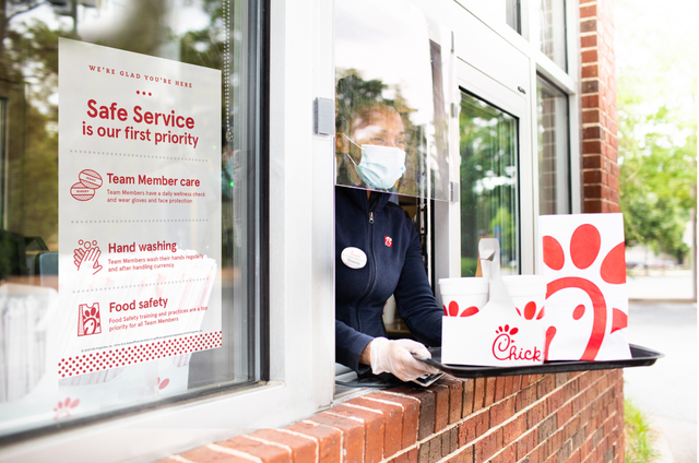 chick fil a drive thru window with white and red food bags
