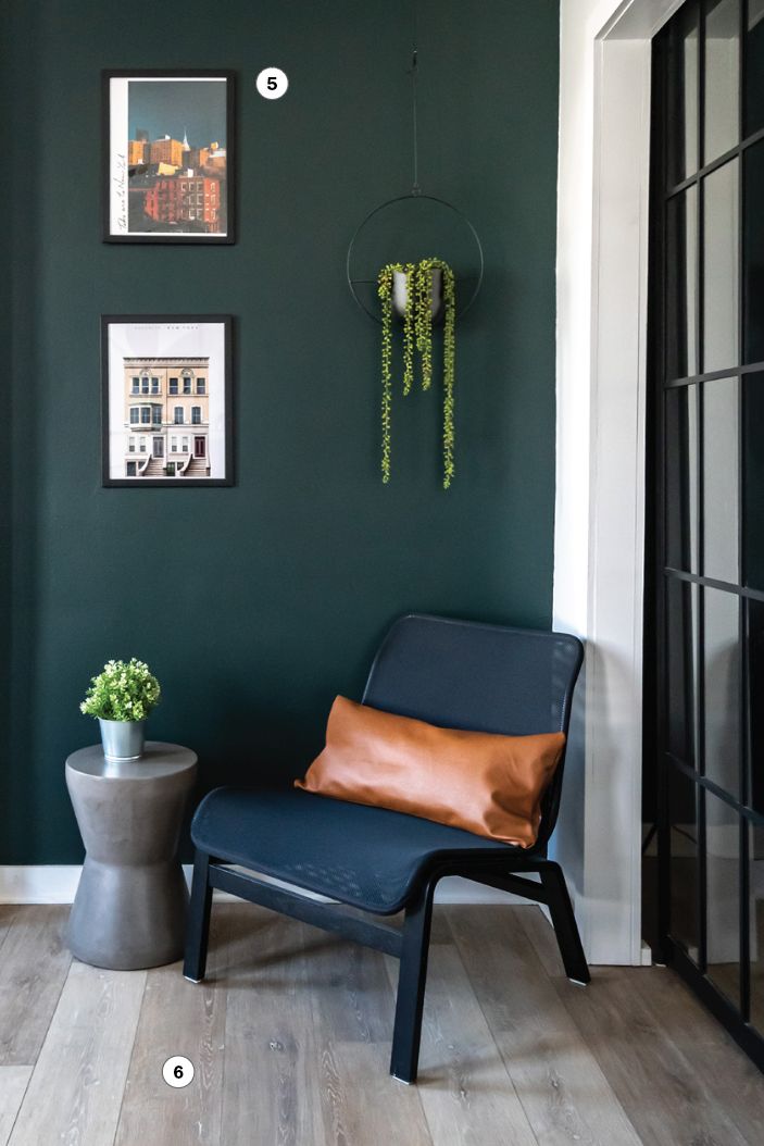 reading nook with green wall and black chair