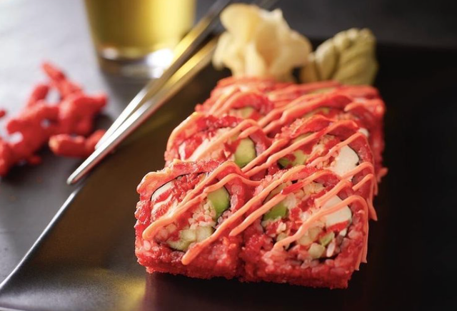 hissho sushi flamin hot cheetos roll with spicy crab, cucumbers, avocado, cream cheese, and hot cheetos crumbles