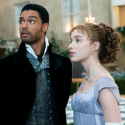 regÉ jean page, a black actor, as simon basset and phoebe dynevor, a white actress, as daphne bridgerton in episode 108 of bridgerton they are standing in an elaborately decorated ballroom