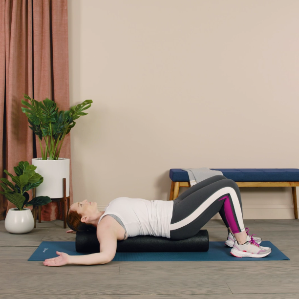 woman using foam roller to stretch back