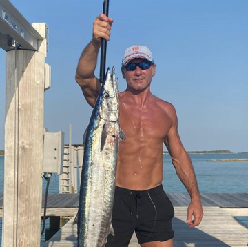 tim mcgraw showing off a fish