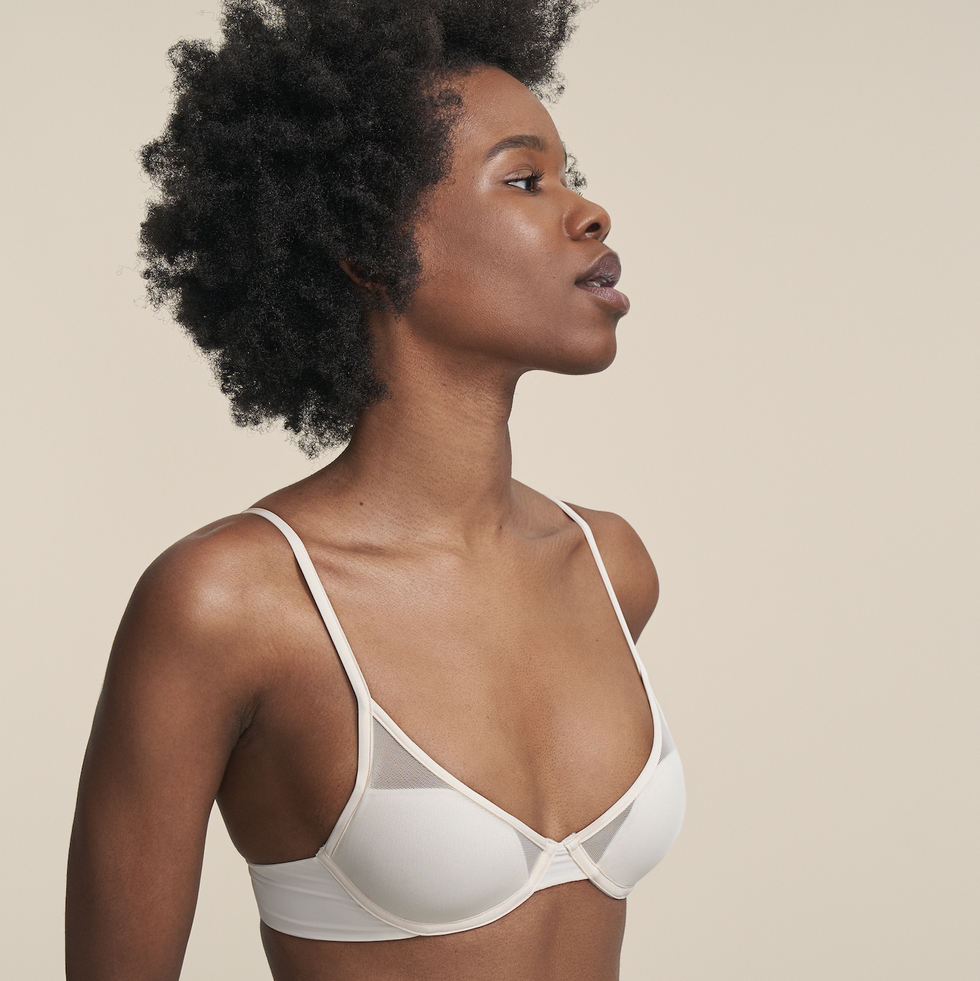 a model wears a white pepper bra in front of a plain backdrop to illustrate a pepper bra for small boobs review 2022