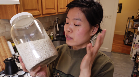 june holds a big jar of glutinous rice