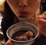 june eats a bowl of tang yuan and black sesame soup