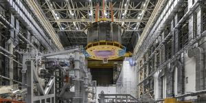 a 110 tonne central solenoid module is moved to the far end of the assembly hall for tests on its instrumentation, sensors and superconducting joints