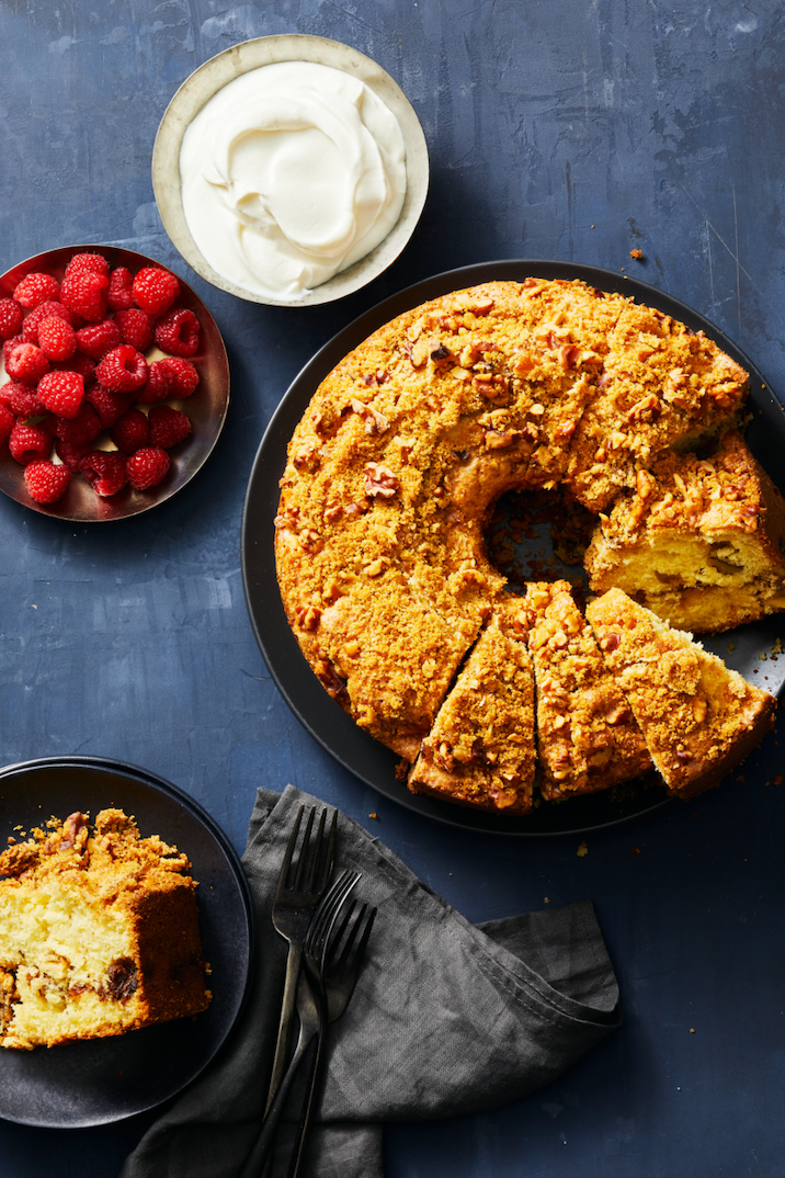 raisinwalnut coffee cake with cream and raspberries on the side