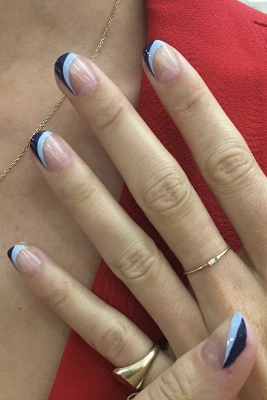 a clear manicure with two different shades of blue, light blue and navy blue, on the top of the nail