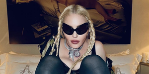 madonna poses in sunglasses in bed