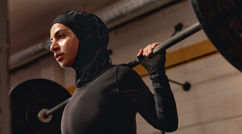person wearing lululemon hijab while lifting weights