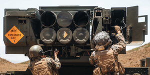 marine corps cpl juan del haro and sgt mauricio sosa load a high mobility artillery rocket system during rim of the pacific 2022 at pohakuloa training area, hawaii, july 18