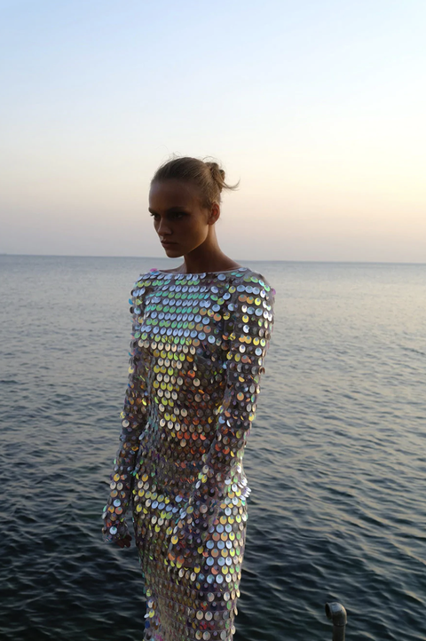 a model wears a sequin paillette dress in a guide to mermaidcore resort trend 2022