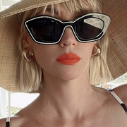 january jones in sunglasses and a hat