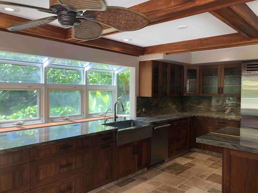 dark kitchen with dark wood cabinets and black pulls and tile floors, before renovation