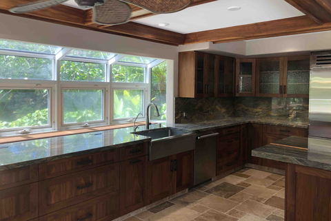 dark kitchen with dark wood cabinets and black pulls and tile floors, before renovation
