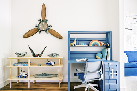 child bedroom with desk and toy shelf