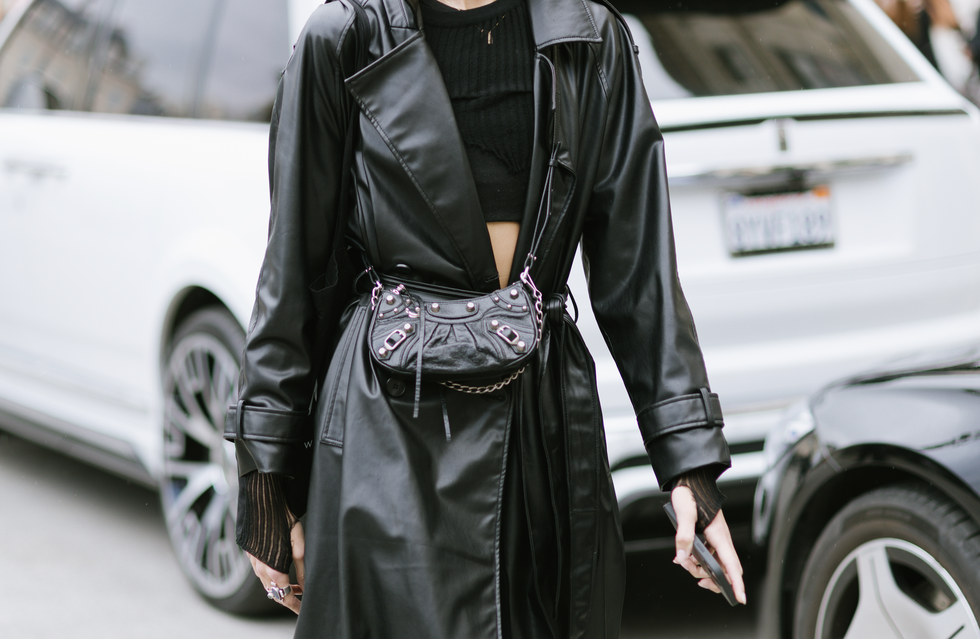 a guest poses wearing a black leather coat and a balenciaga studded bag after the schiaparelli show in place vendome during paris fashion week  womenswear springsummer 2023 on september 29, 2022 in paris, france
