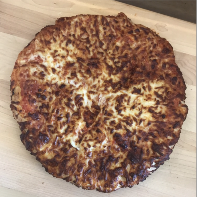 frozen air fried pizza on cutting board