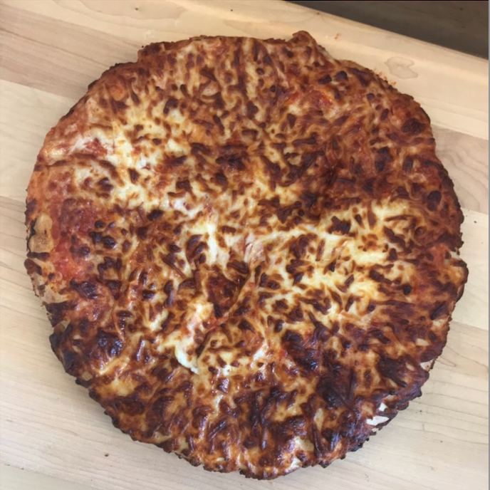 frozen air fried pizza frozen air fried pizza on cutting board