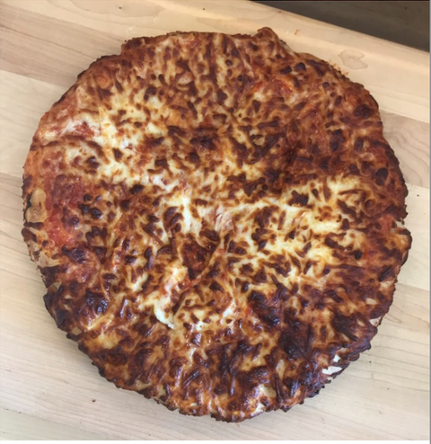 frozen air fried pizza on cutting board