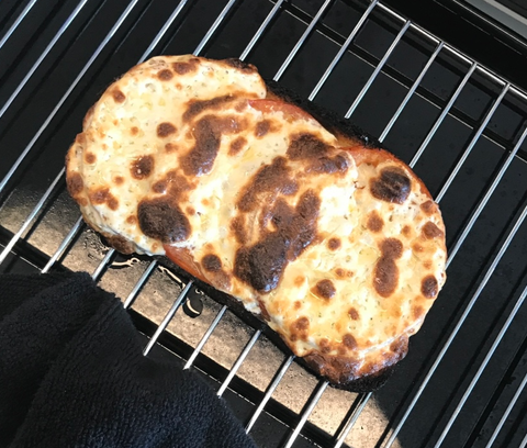 melted mozzarella cheese on toaster oven tray