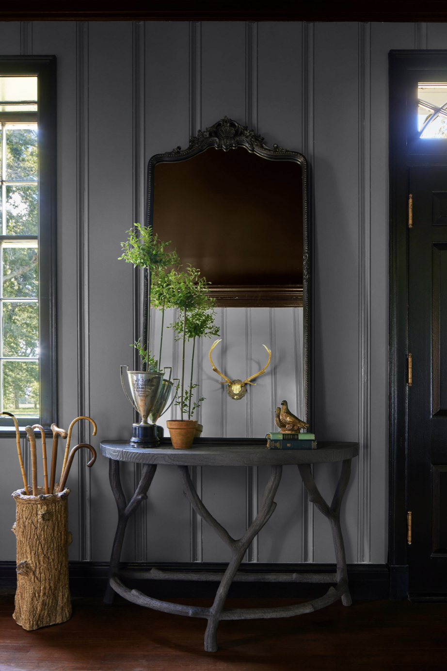 vignette of entryway with large mirror placed on demilune