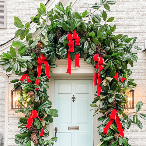 a christmas door with greenery