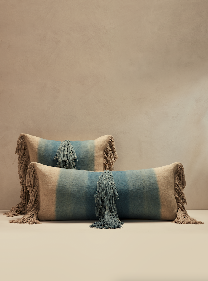 a set of two striped blue pillows