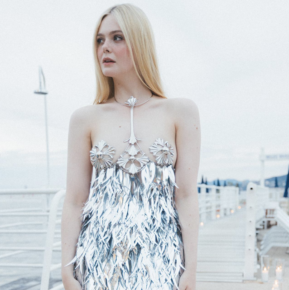Elle Fanning Tops Cannes Best Dressed Lists in a Dress with Metallic Pasties and Silver Fringe