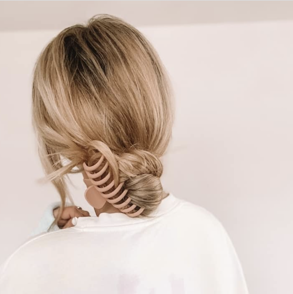 blonde hair twisted into bun and secured with claw clip
