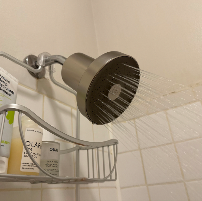 the jolie filtered showerhead with water running through