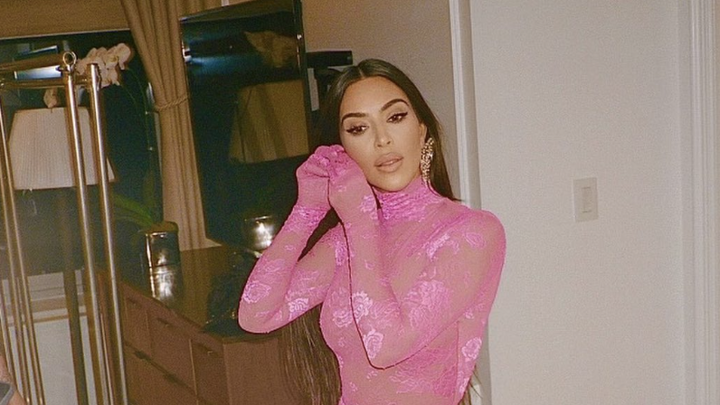 Kim Kardashian is covered in gold dust as she models a pale pink leotard