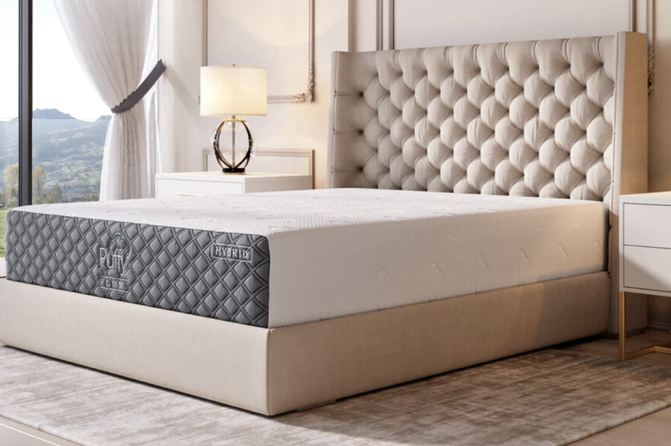 a side shot of the puffy lux mattress in a bedroom setup