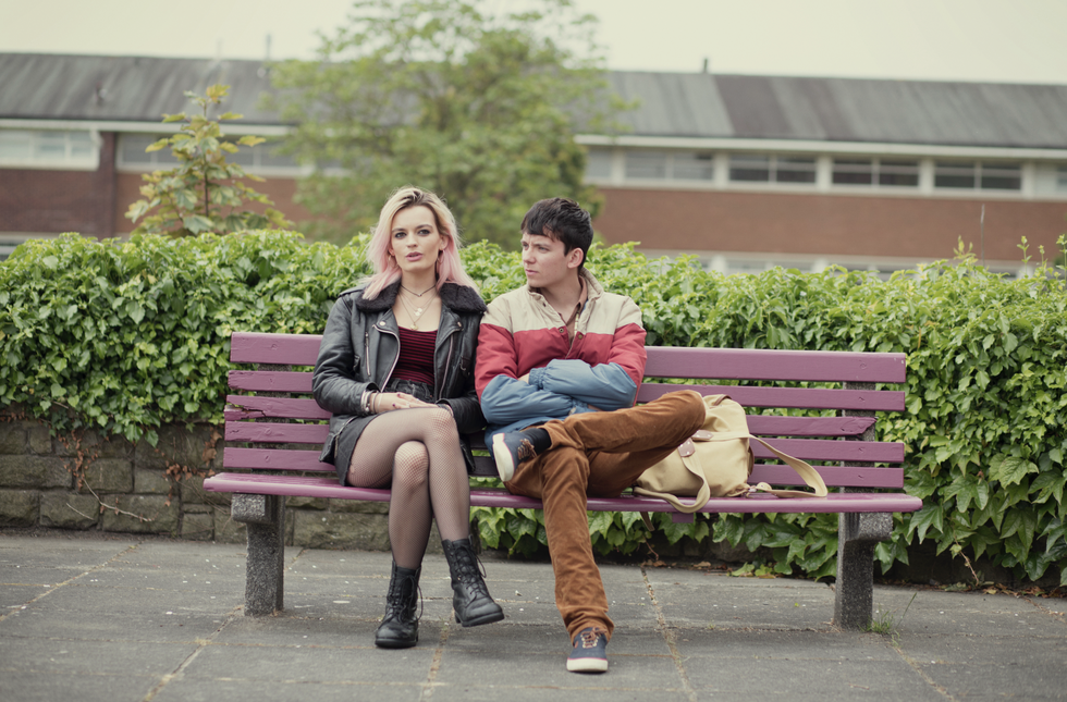 sex education characters maeve and otis on a bench