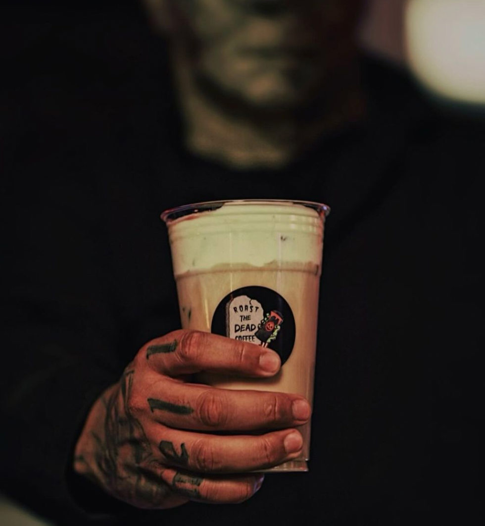 a person holding a glass of beer