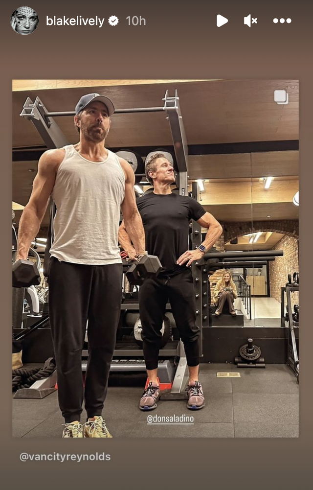 a person standing next to a person in a gym