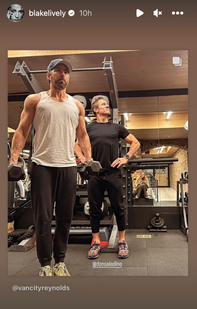 a person standing next to a person in a gym