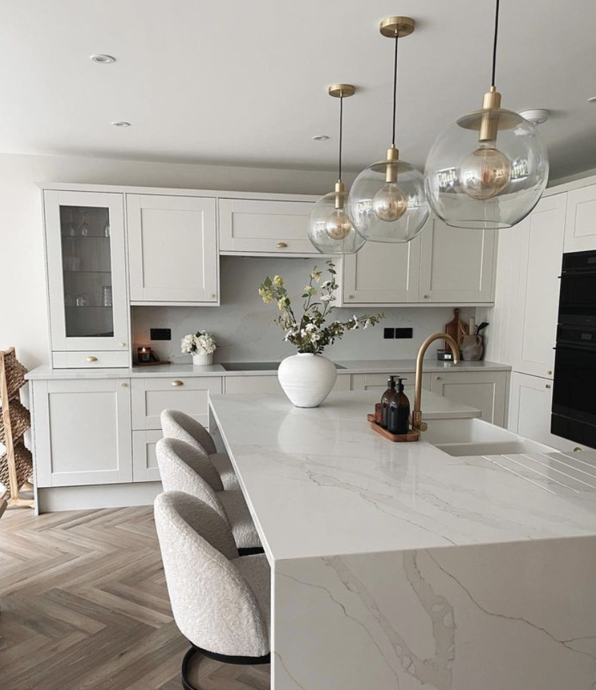 a kitchen with a white table and white cabinets