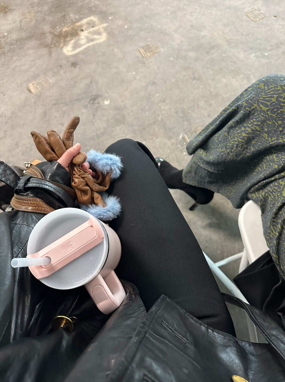 a person lying on the ground with a hat and a cigarette