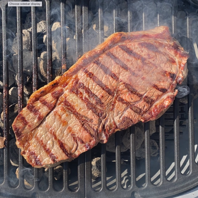 a piece of meat on a grill a piece of meat on a grill
