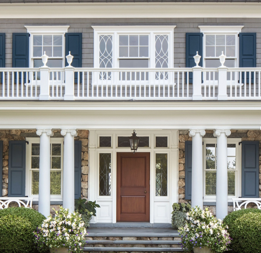 a white house with a large front porch and a large front door